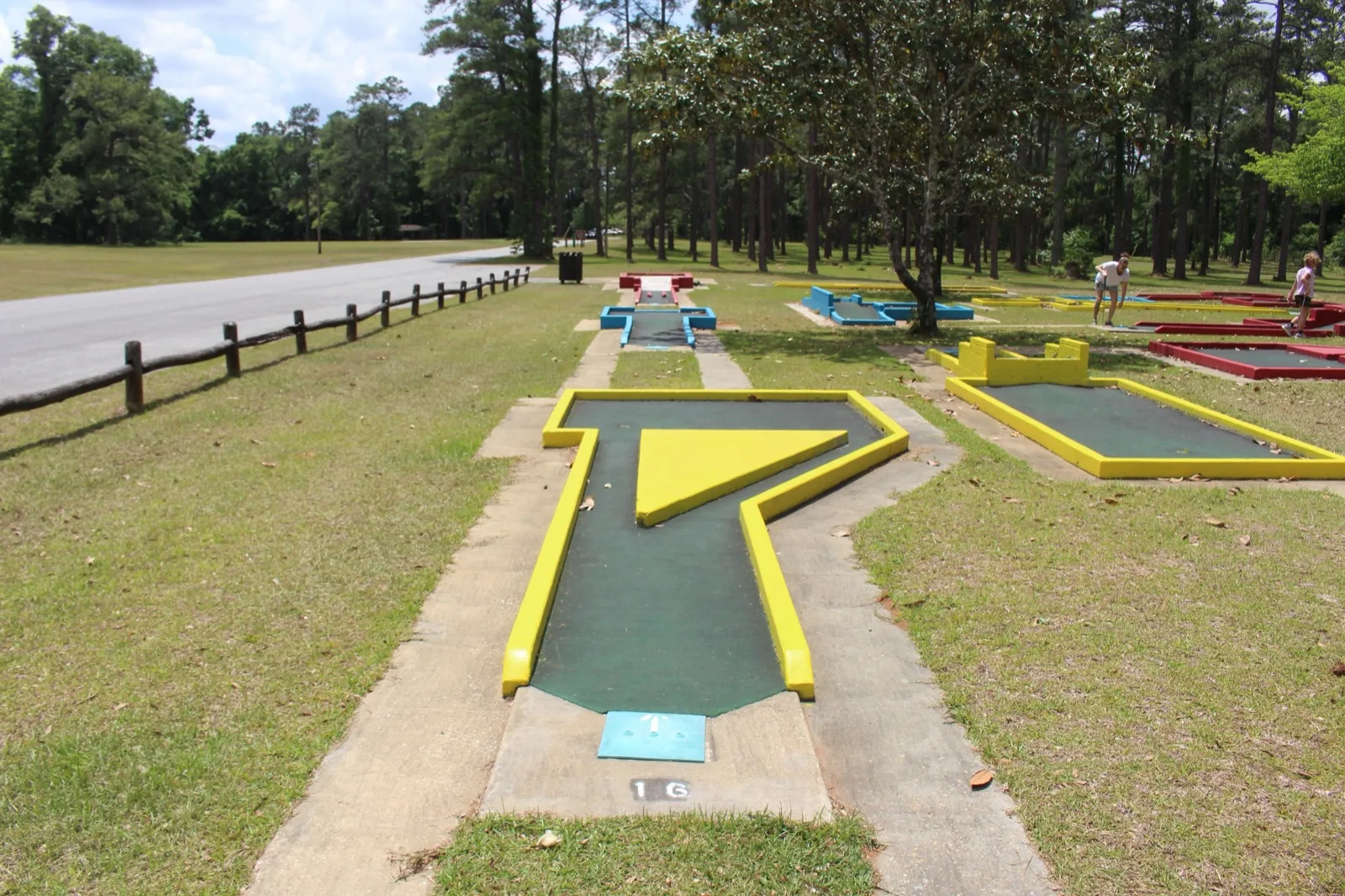 An outdoor miniature golf course among trees