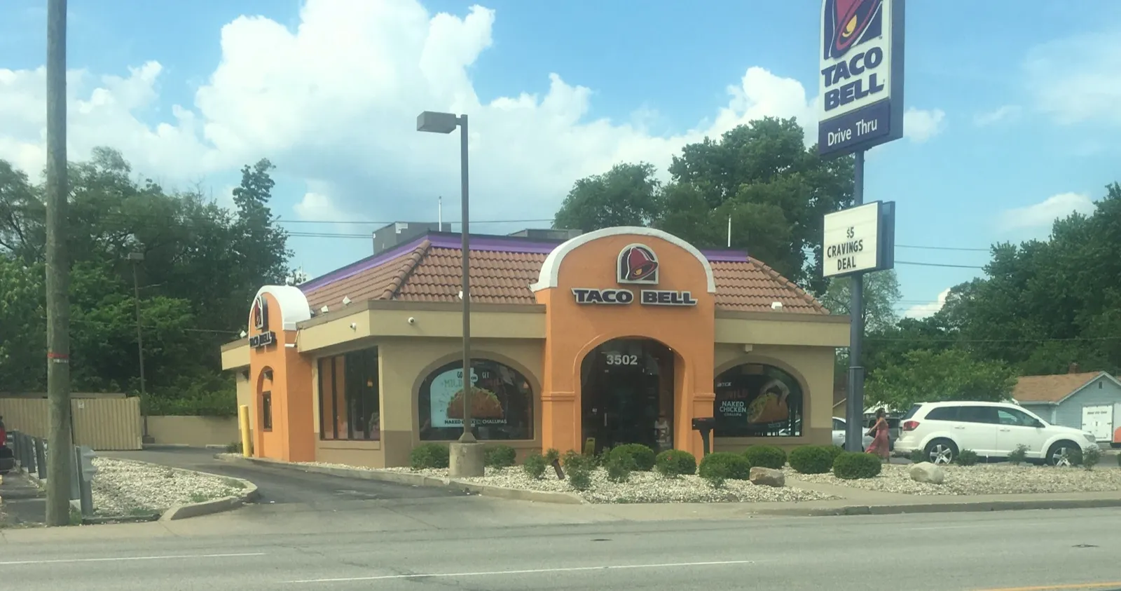 An older-style Taco Bell restaurant building with an orange tile roof
