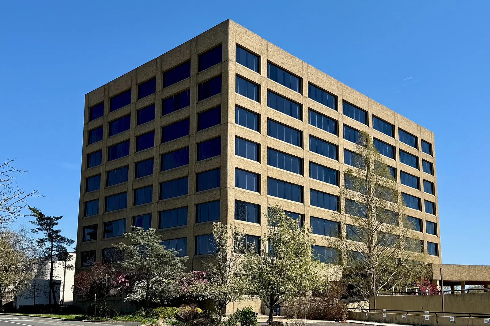 Four Echelon Plaza in Voorhees, an eight-story precast concrete office building with rows of dark windows